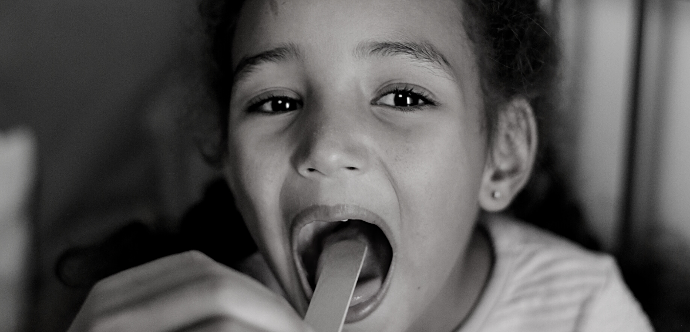 Child with throat being examined